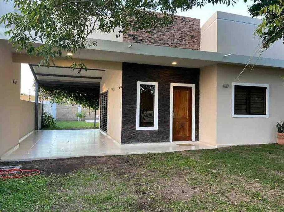 a home with a garage and a house at Casa de verano en San Bernardino in San Bernardino