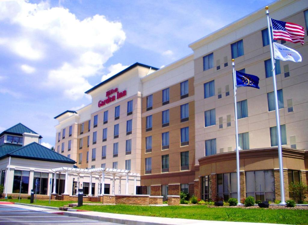 a hotel with two flags in front of it at Hilton Garden Inn Indianapolis South/Greenwood in Indianapolis