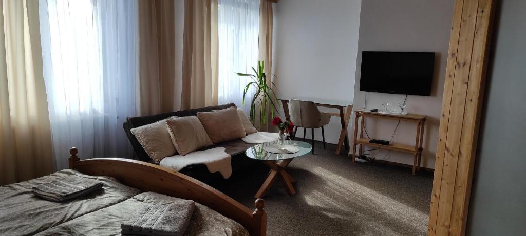 a living room with a couch and a television at U Certa in Čerčany