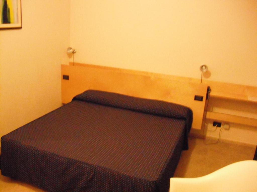 Postel nebo postele na pokoji v ubytování Albergo Ristorante Saverino