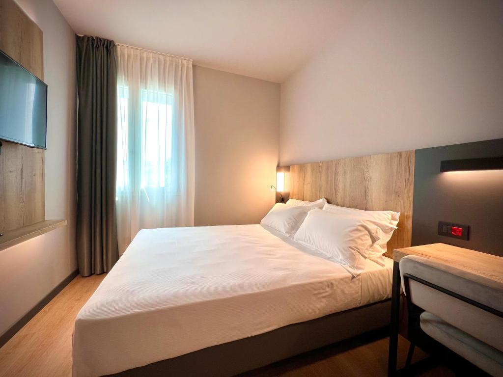Postel nebo postele na pokoji v ubytování Hotel Leonessa