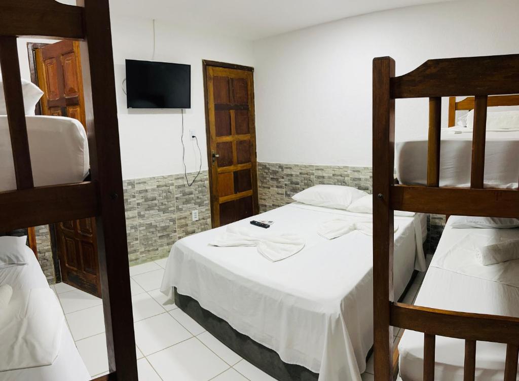 Postel nebo postele na pokoji v ubytování Pousada Timbalada