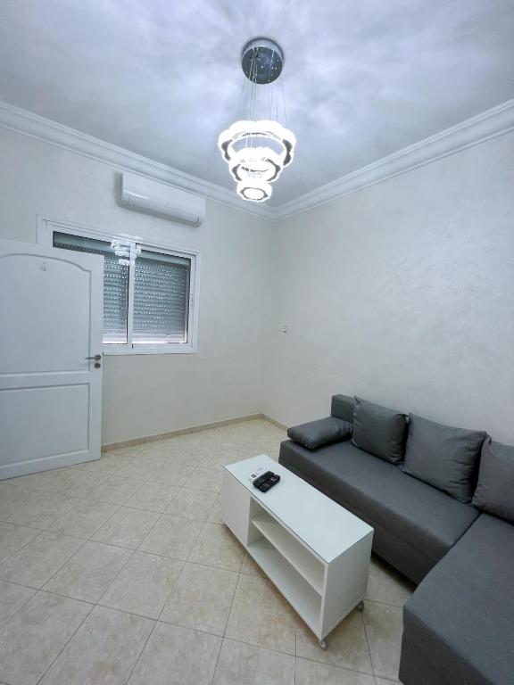 a living room with a couch and a table at Rif Appartment in Al Hoceïma