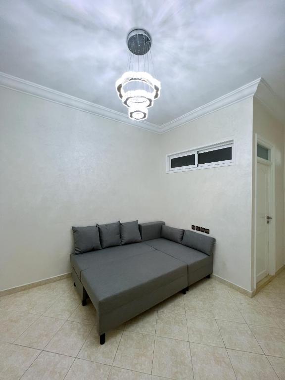 a couch in a room with a ceiling at Rif Appartment in Al Hoceïma