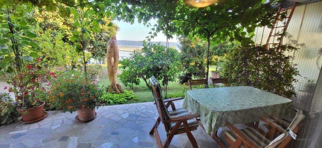 a table and chairs on a patio with plants at Apartment Salt Pans view in Portorož