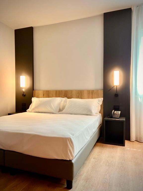 Postel nebo postele na pokoji v ubytování Hotel Leonessa