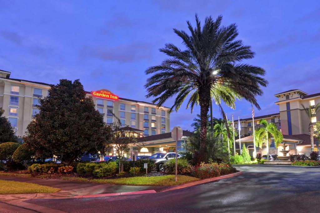 a palm tree in front of a hotel at Hilton Garden Inn Orlando Lake Buena Vista in Orlando