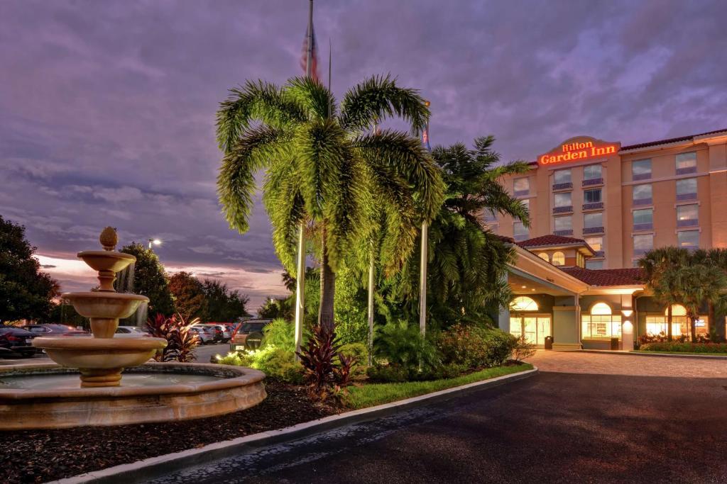 a hotel with a fountain in front of a building at Hilton Garden Inn Orlando Lake Buena Vista in Orlando