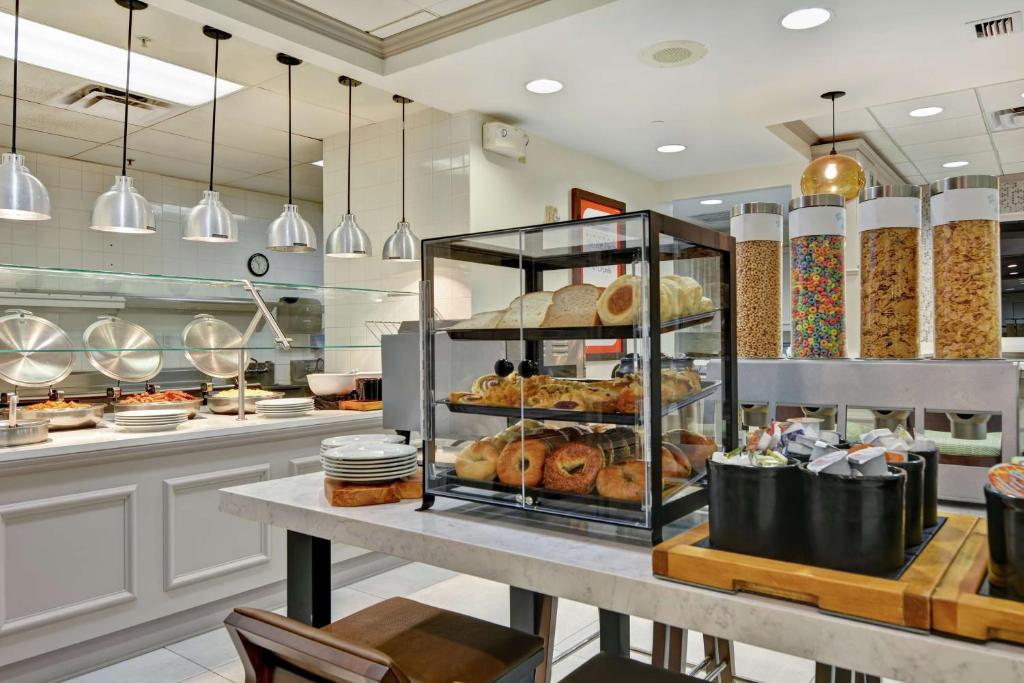 a bakery with a display case filled with pastries at Hilton Garden Inn Orlando Lake Buena Vista in Orlando