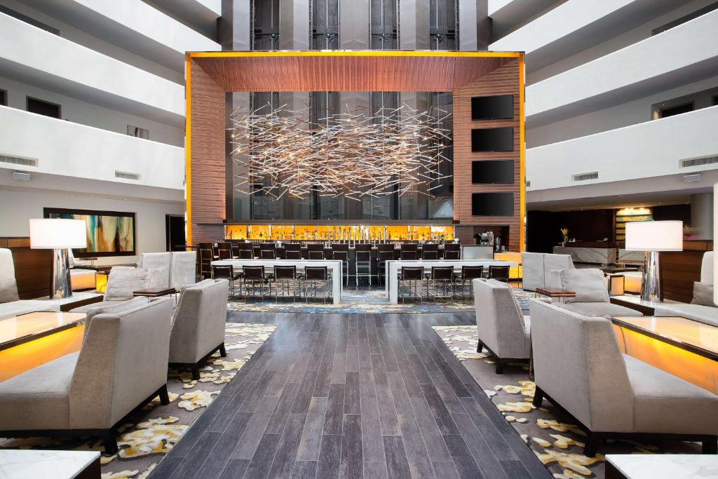 a lobby of a hotel with tables and chairs at Hilton McLean Tysons Corner in Tysons Corner