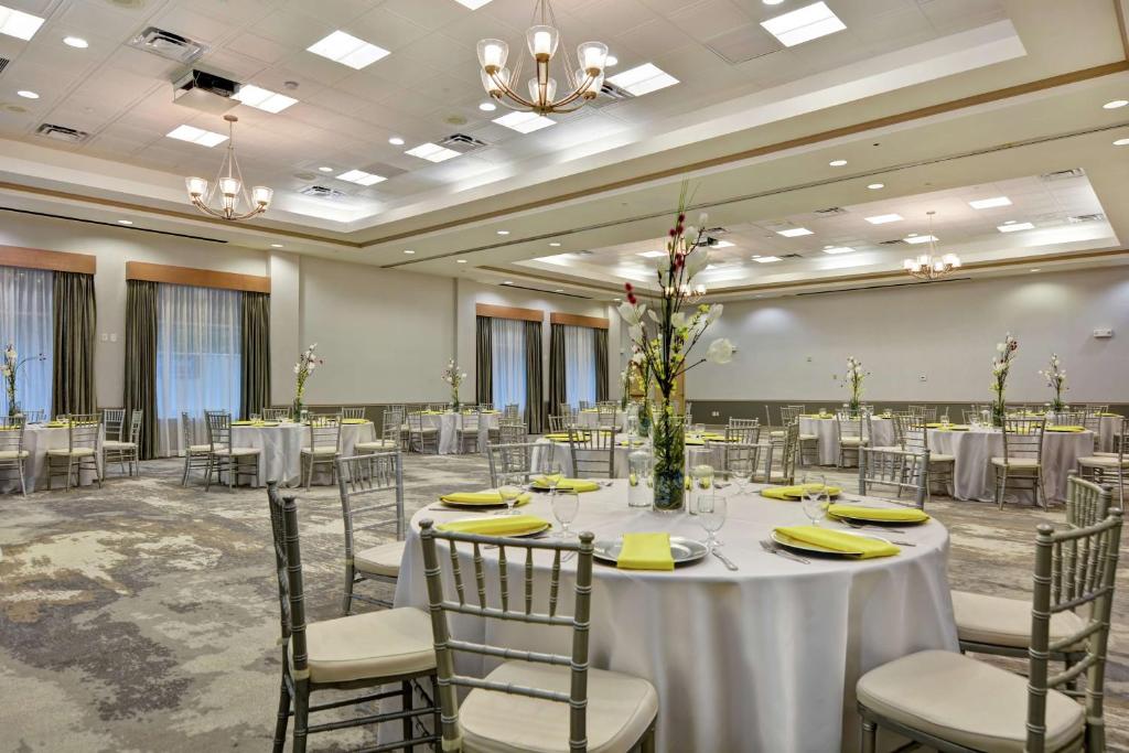 a ballroom with tables and chairs and a room filled with tables and chairsktop at Hilton Garden Inn Orlando Lake Buena Vista in Orlando