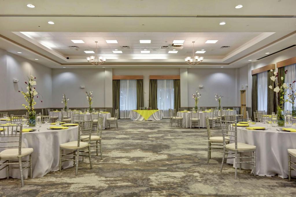 a banquet hall with tables and chairs in a room at Hilton Garden Inn Orlando Lake Buena Vista in Orlando