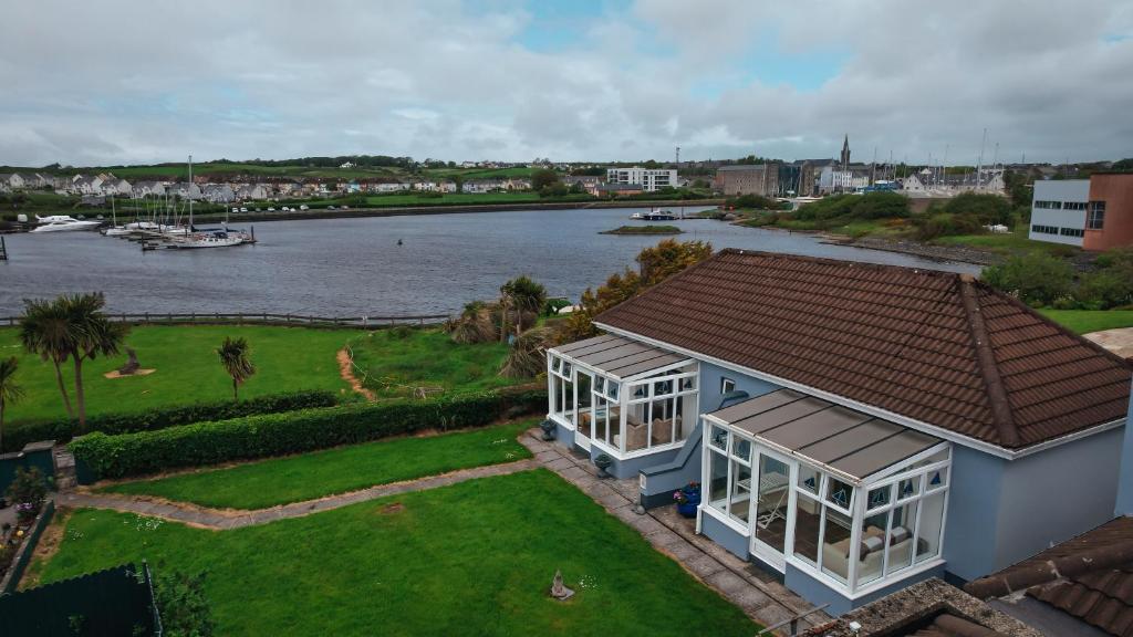 a house with a view of a river at Ferry Lodge Cottage in Kilrush