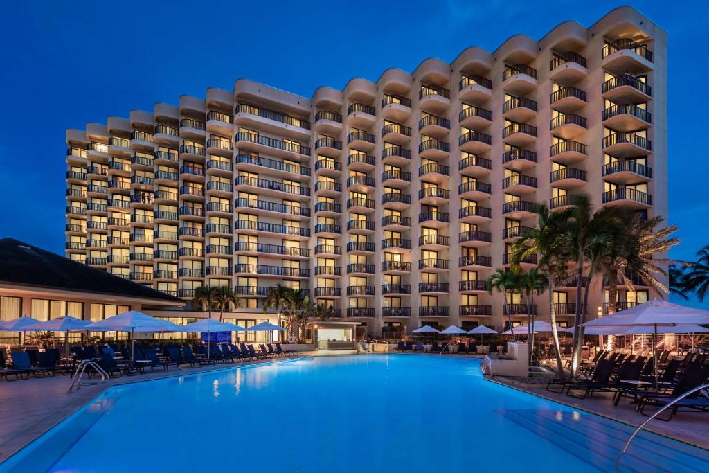 a view of the hotel from the pool at night at Hilton Marco Island Beach Resort and Spa in Marco Island