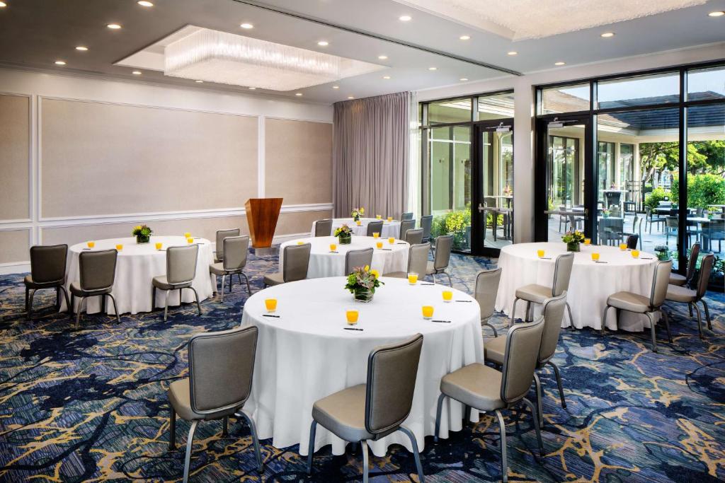 a conference room with round tables and chairs at Hilton Marco Island Beach Resort and Spa in Marco Island