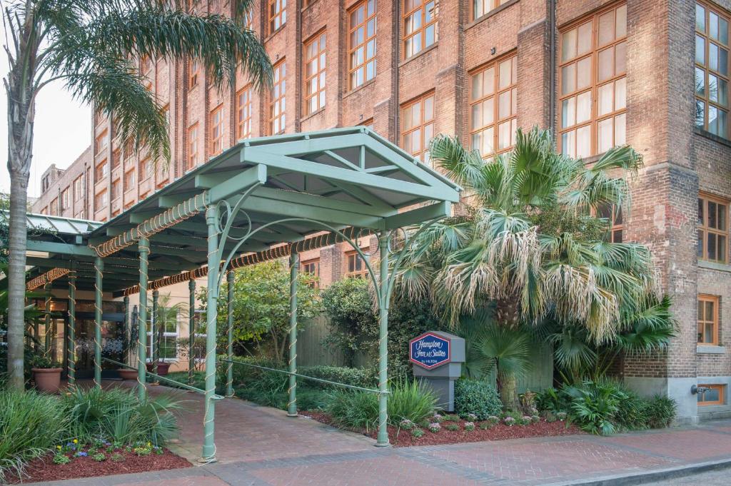 a building with a blue sign in front of it at Hampton Inn and Suites New Orleans Convention Center in New Orleans