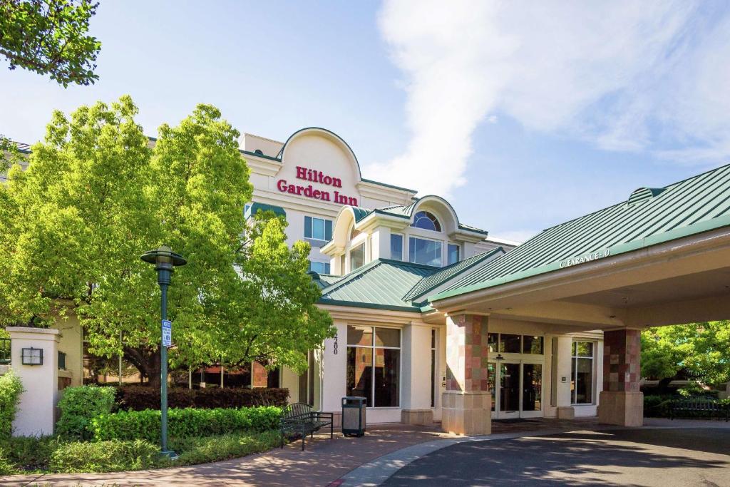 a hotel with a sign on the front of a building at Hilton Garden Inn Fairfield in Fairfield