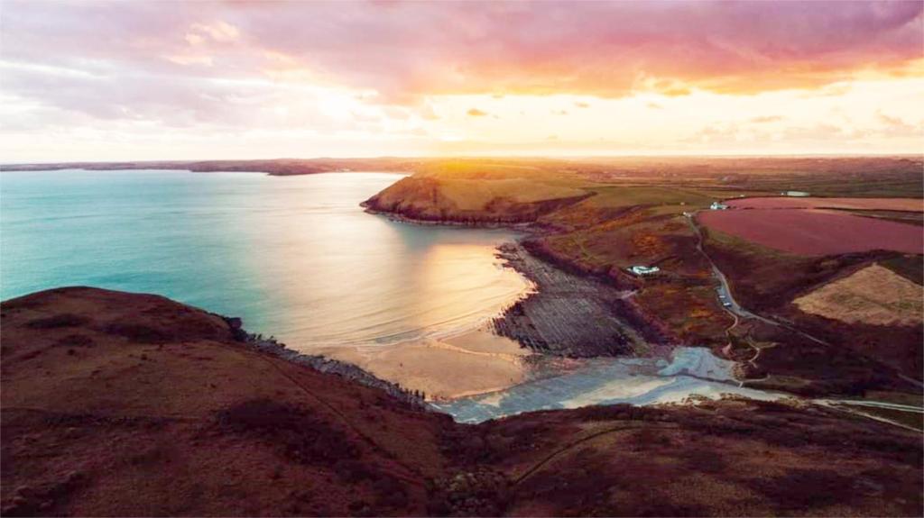 an aerial view of a body of water at The Rum Shack Manorbier Castle Inn in Manorbier