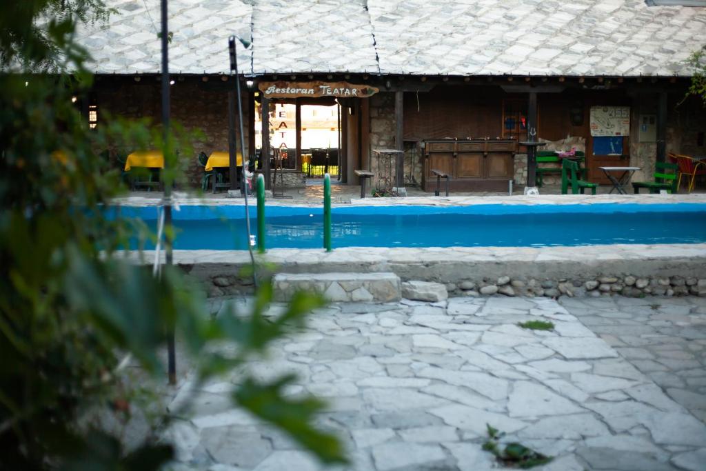 a swimming pool in front of a building at Apartments Azra in Mostar