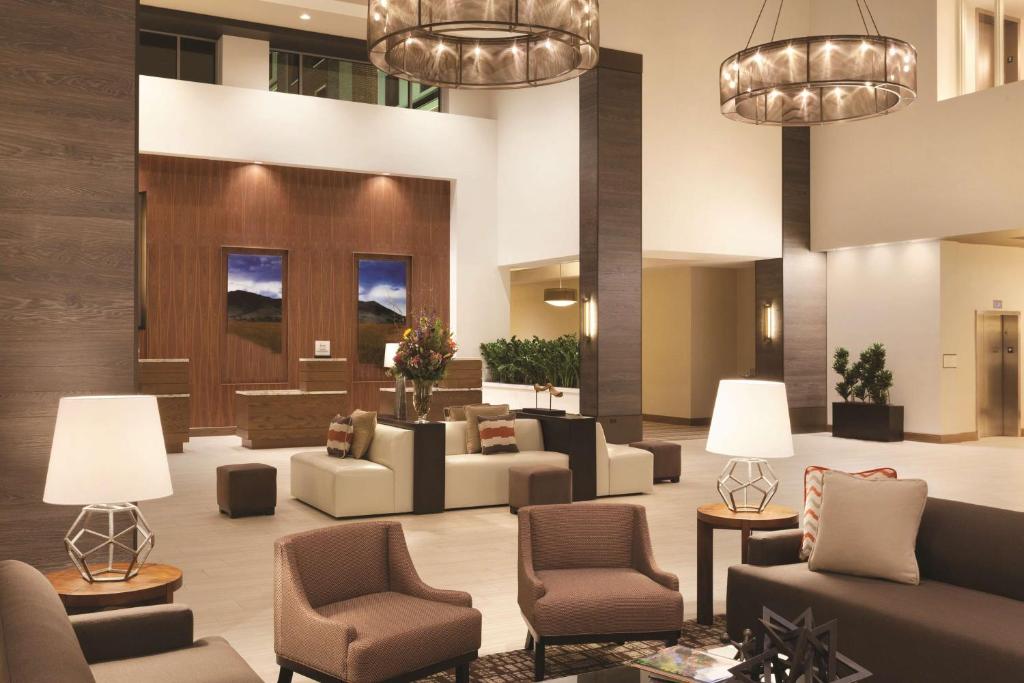 a lobby with couches and chairs and lights at Embassy Suites Oklahoma City Downtown/Medical Center in Oklahoma City