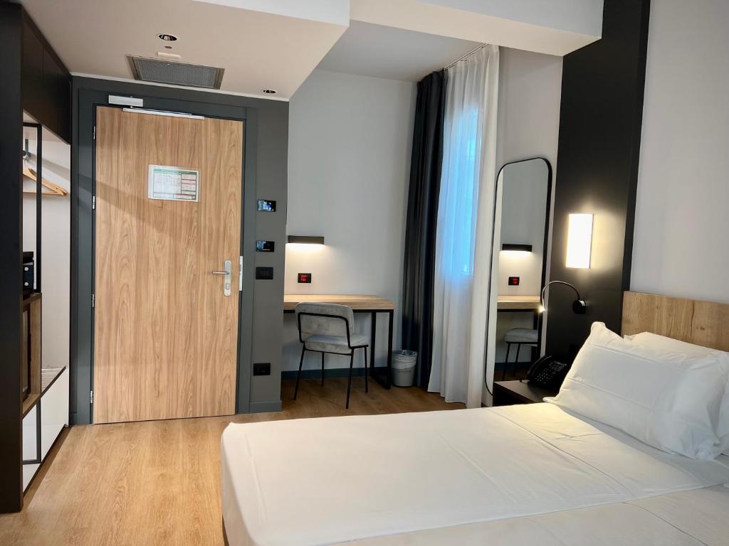 Postel nebo postele na pokoji v ubytování Hotel Leonessa