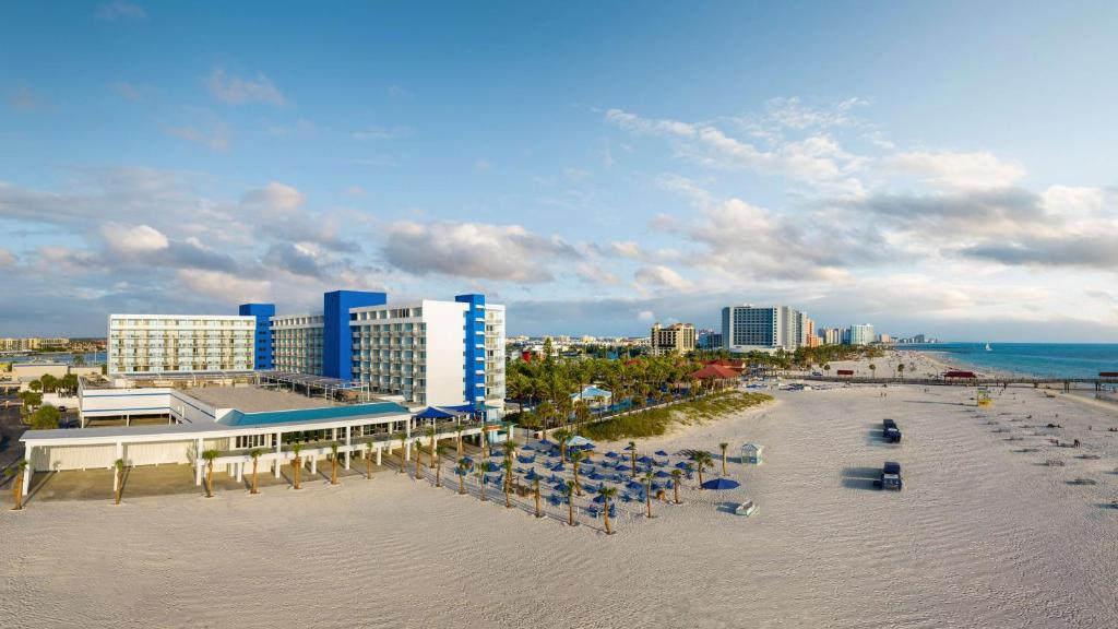 an aerial view of a beach with chairs and buildings at Hilton Clearwater Beach Resort & Spa in Clearwater Beach