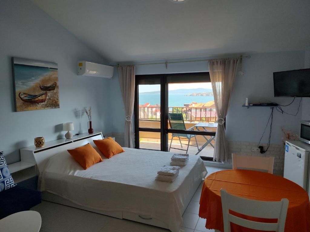 a bedroom with a bed with a view of the ocean at Studio Senso di Mare in Sozopol