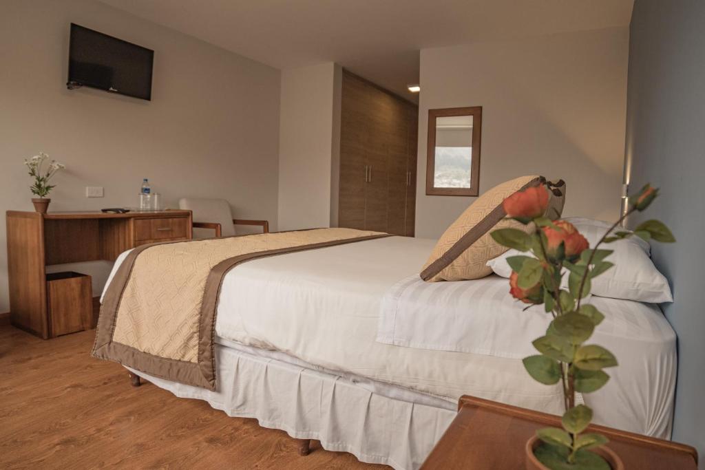 Postel nebo postele na pokoji v ubytování Hotel Ambato