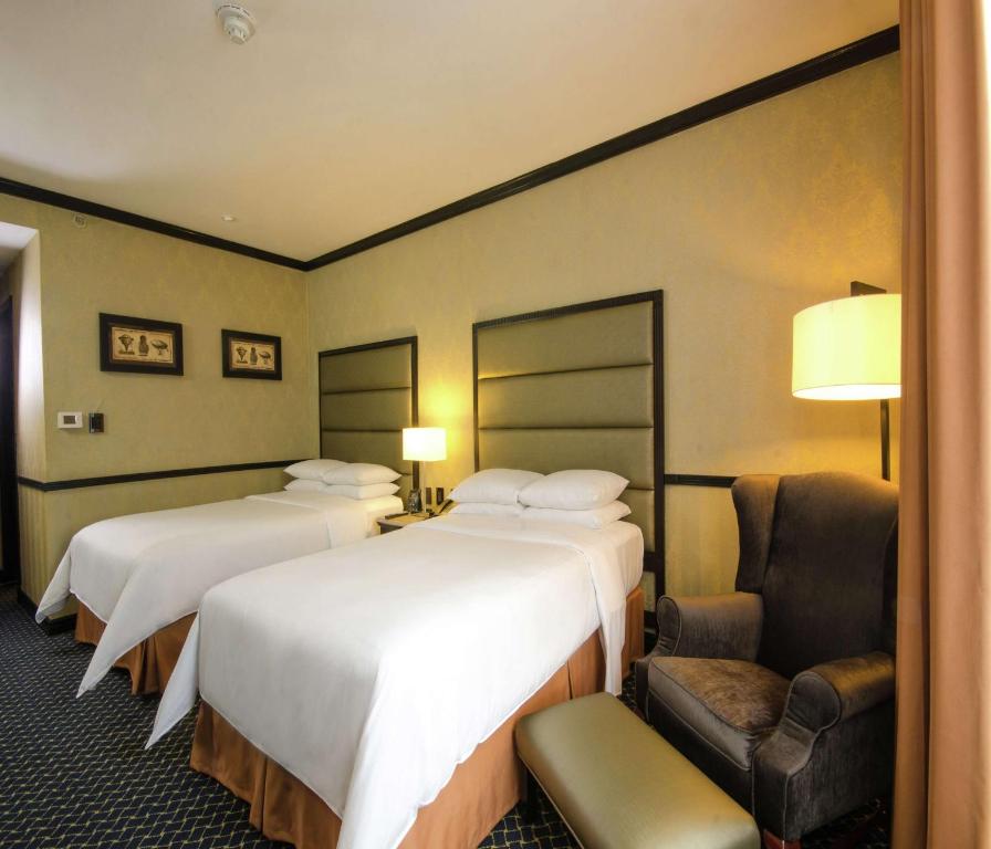 Postel nebo postele na pokoji v ubytování Hilton Princess San Pedro Sula