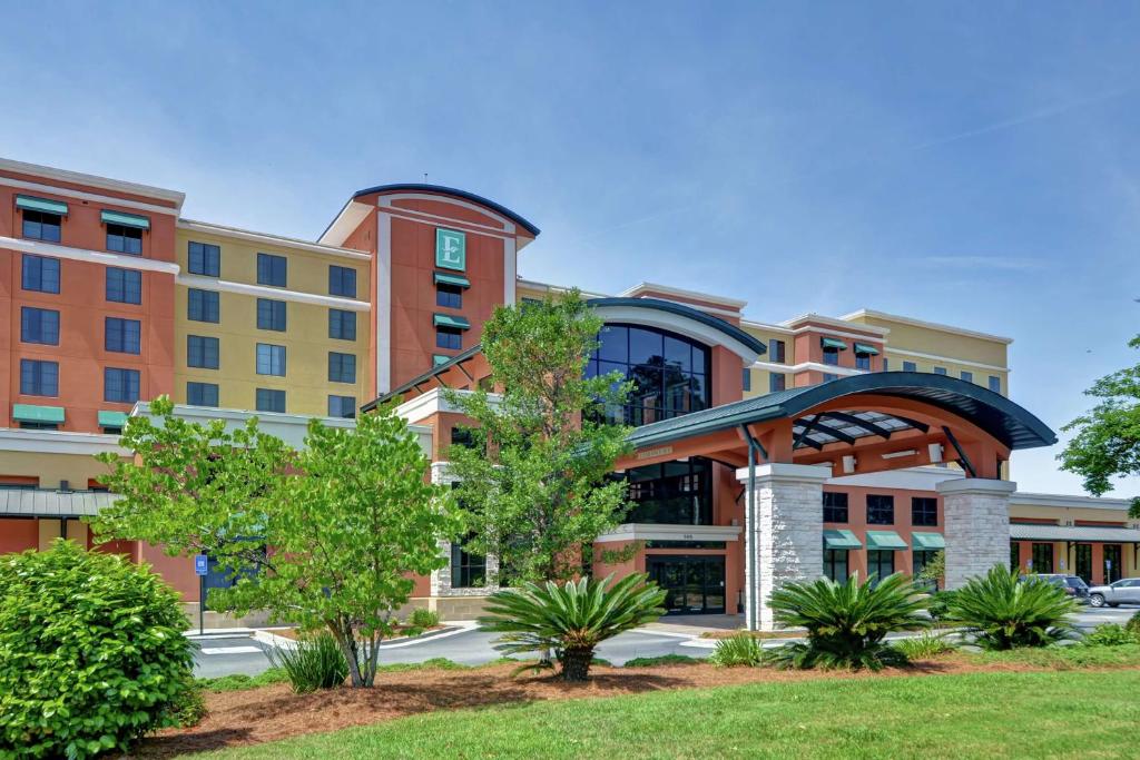 an office building with trees in front of it at Embassy Suites Savannah Airport in Savannah