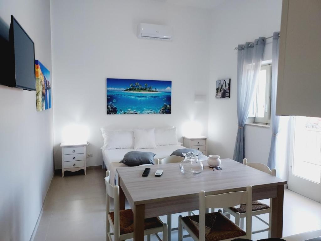 a white living room with a table and a couch at Villa Capitani in Torre Canne