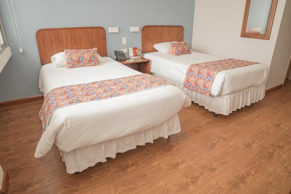 Postel nebo postele na pokoji v ubytování Hotel Ambato