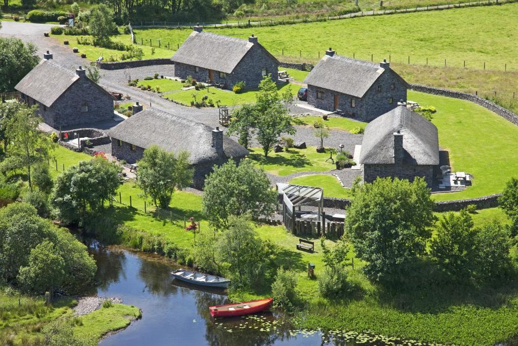 an aerial view of a village with boats in a river at Clan Cottages in Oban