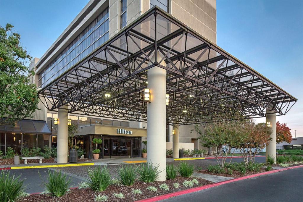 a view of a building with a metal roof at Hilton Sacramento Arden West in Sacramento