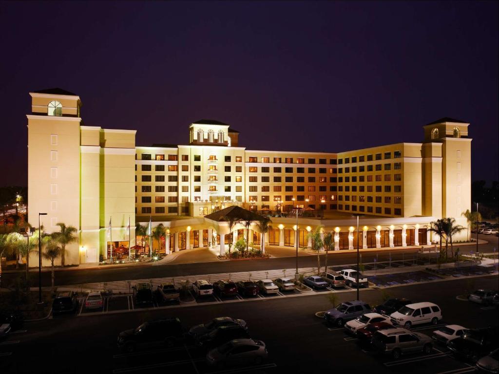 a large building with cars parked in a parking lot at DoubleTree Suites By Hilton Anaheim Resort/Convention Center in Anaheim