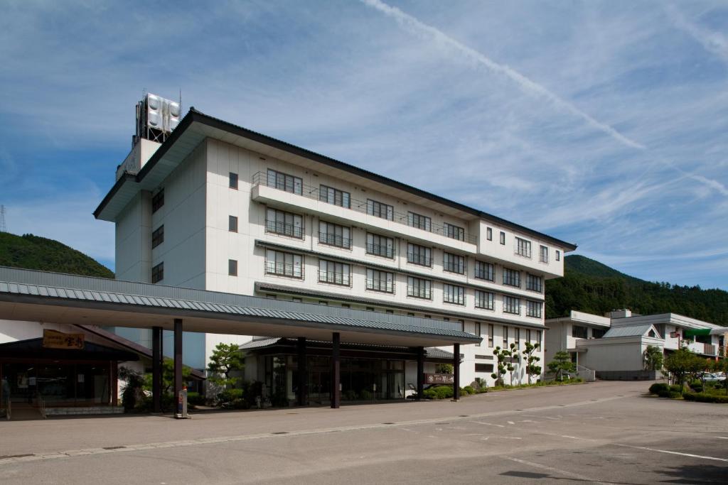 a large white building with a lot of windows at Hotel Gujo Hachiman in Gujo