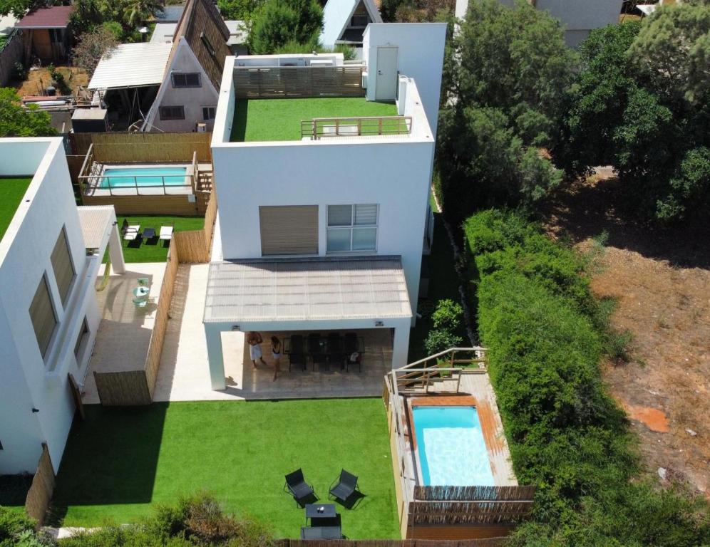 an aerial view of a house with a swimming pool at הבית בחוף הזהב in Caesarea