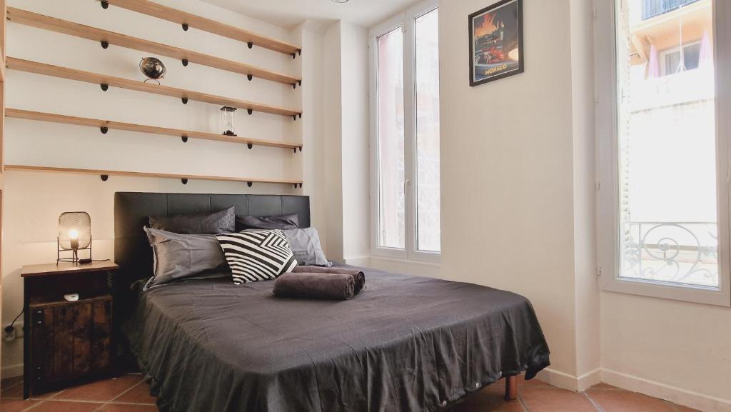 a bedroom with a large bed with a wooden wall at Loft Place Massena in Nice
