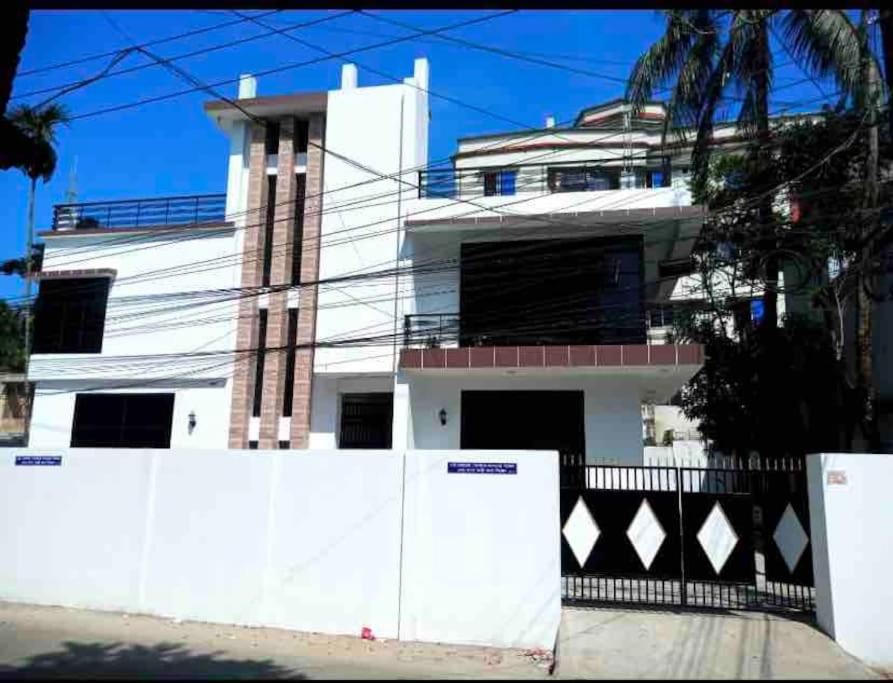 a white building with a fence in front of it at *NEW BUILD* Luxury Holiday Home in Sylhet