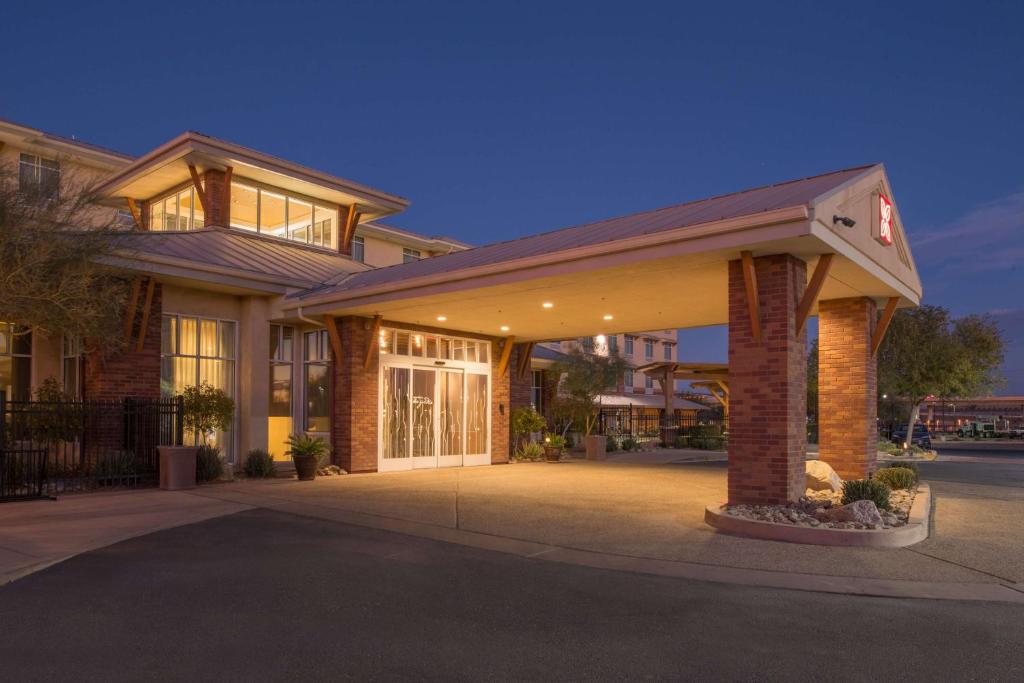 - un grand bâtiment avec une terrasse couverte à l'avant dans l'établissement Hilton Garden Inn Yuma Pivot Point, à Yuma