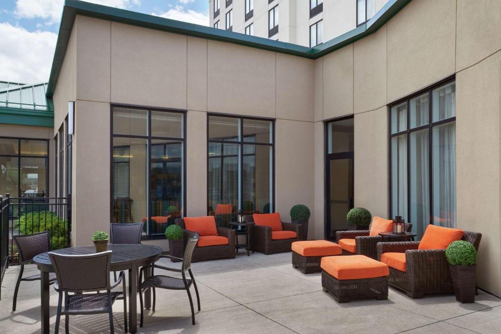 a patio with tables and chairs and a building at Hilton Garden Inn Toronto Airport West/Mississauga in Mississauga