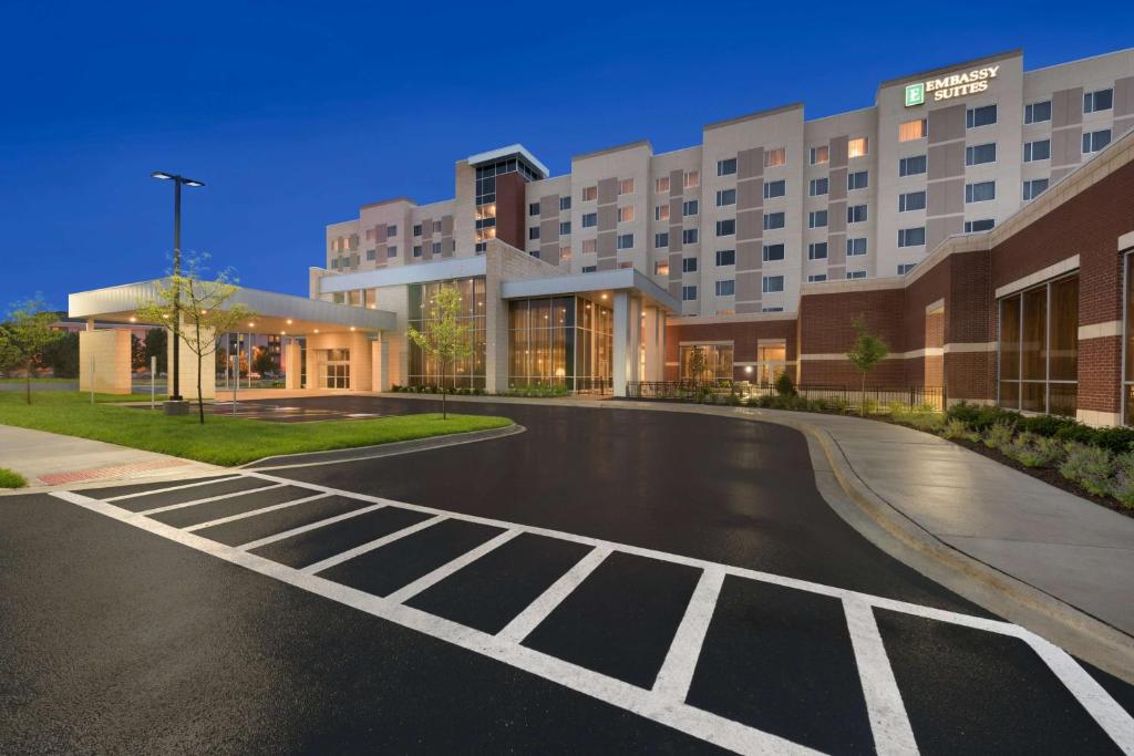 an empty parking lot in front of a hotel at Embassy Suites by Hilton Chicago Naperville in Naperville