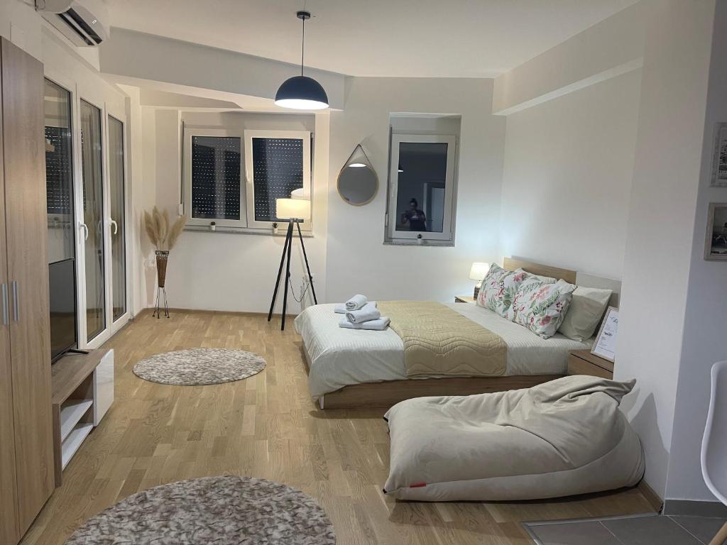 a bedroom with two beds and a lamp at R&B Apartment City Center in Ohrid