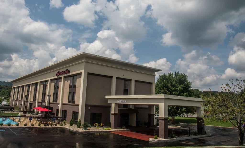 a large building with a restaurant in a parking lot at Hampton Inn Summersville in Summersville