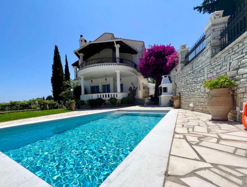 a house with a swimming pool in front of a house at Casa StaLa in Kastanéa