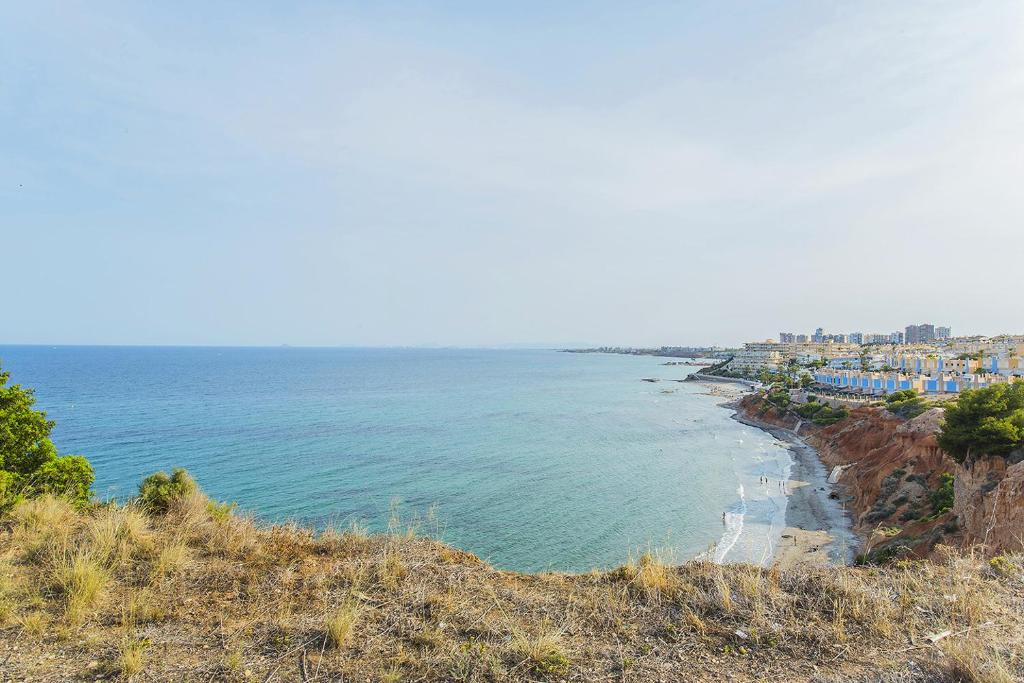 vistas al océano desde una colina en 244 Cabo Roig Luxury -Alicante Holiday, en Cabo Roig