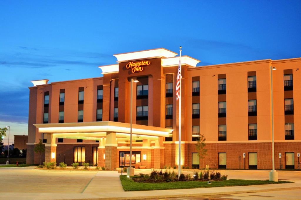 a large brick building with a sign on it at Hampton Inn Lincoln Airport, Ne in Lincoln