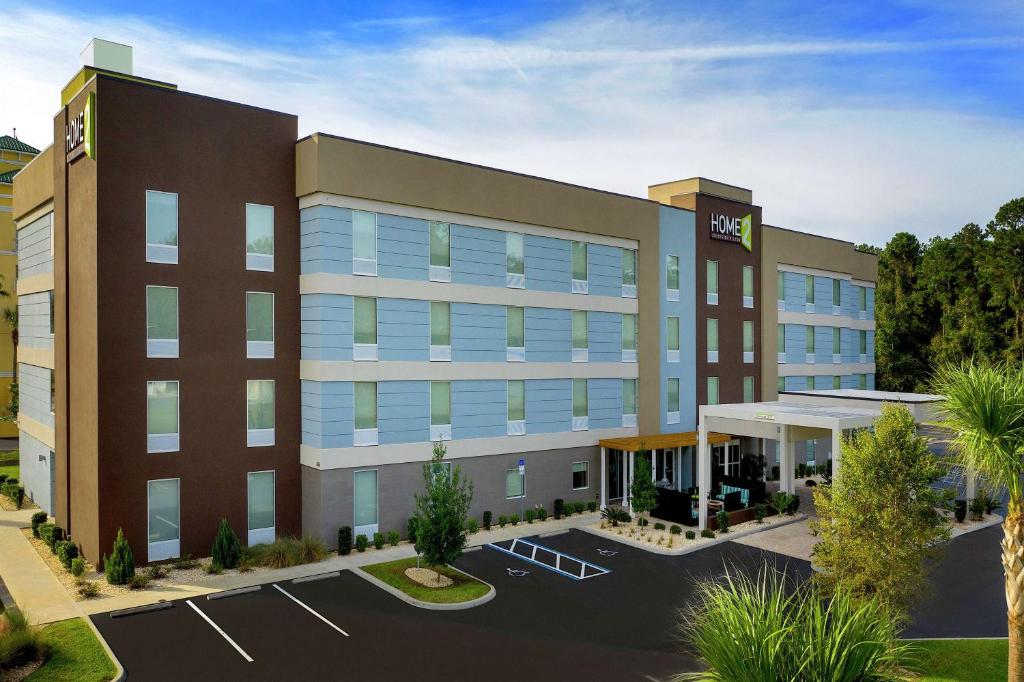 a rendering of a hotel building with a parking lot at Home2 Suites by Hilton Lake City in Lake City