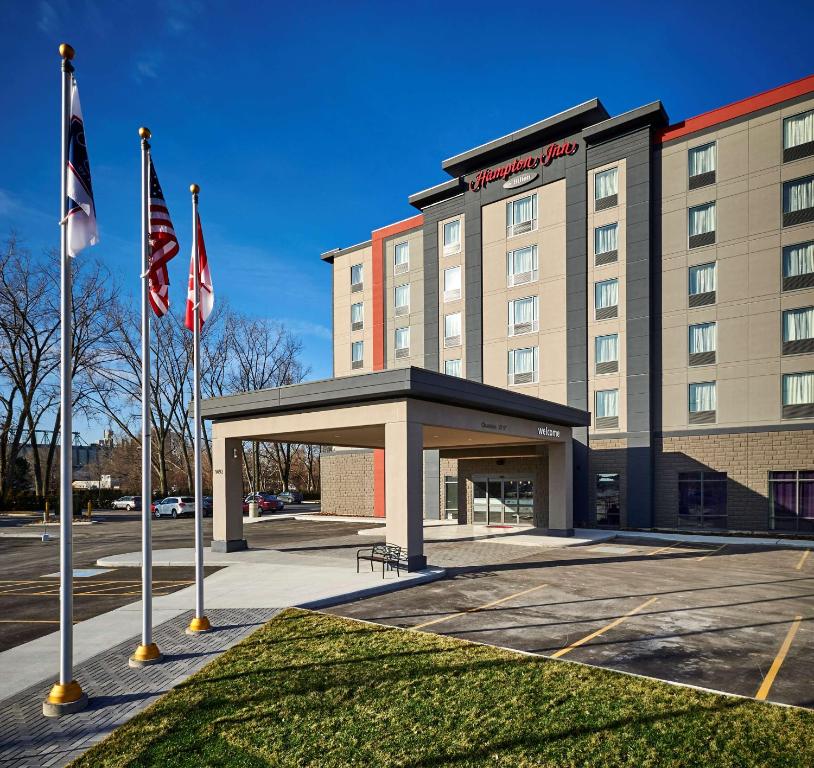 a hotel building with flags in front of it at Hampton Inn by Hilton Sarnia/Point Edward in Point Edward