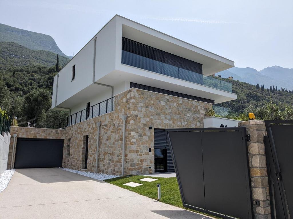 a house on a hill with a garage at Olivo Luxury Apartments in Malcesine